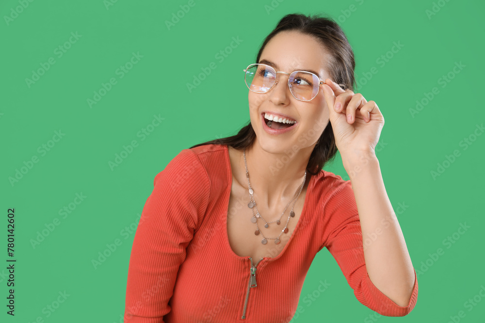 Young woman in eyeglasses on green background Young woman in eyeglasses on green background