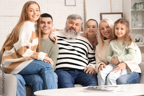 Big family sitting on sofa ...