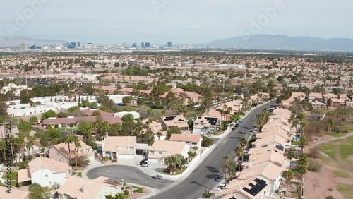 Aerial pulback view of Henderson Las Vegas suburbs with roads and city skyline