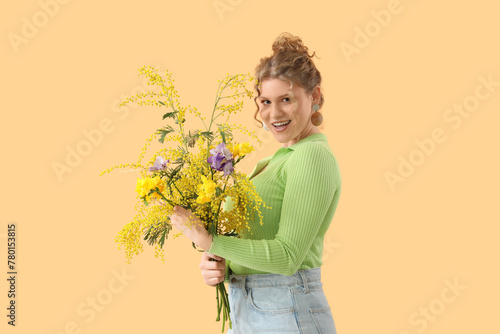 Smiling young woman holding...
