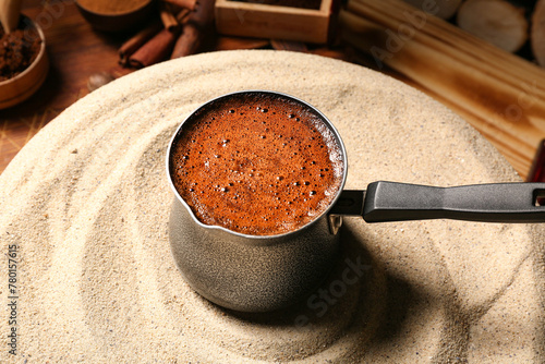 Cezve with hot coffee on ta...