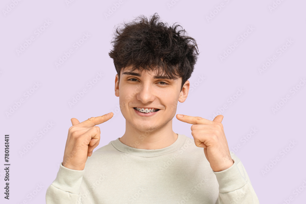 Smiling young man with dental braces on light background Smiling young man with dental braces on light background