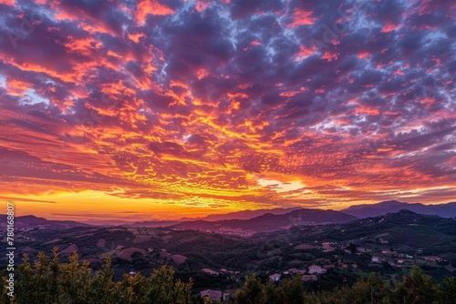 Vibrant fiery sunset sky with orange, pink, purple and yellow colors, panoramic landscape © Lucija