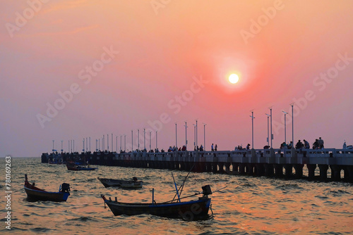 Sunset over the long bridge and boats at the sea, Bangsaen, Chonburi Province, Thailand