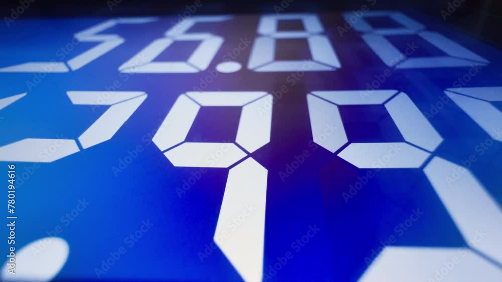 Digital gas price sign showing cost in dollars and volume in gallons under the night sky at a fuel station, with vibrant blue illumination. Footage 4K. Digital gas price sign showing cost in dollars and volume in gallons under the night sky at a fuel station, with vibrant blue illumination. Footage 4K.