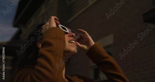 Ottawa Ontario Canada - April 8th 2024 - Woman wears iso 123 12-2 glasses and watches solar eclipse