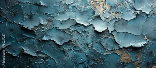 A detailed close-up of peeling blue paint coming off an aged and weathered wall surface