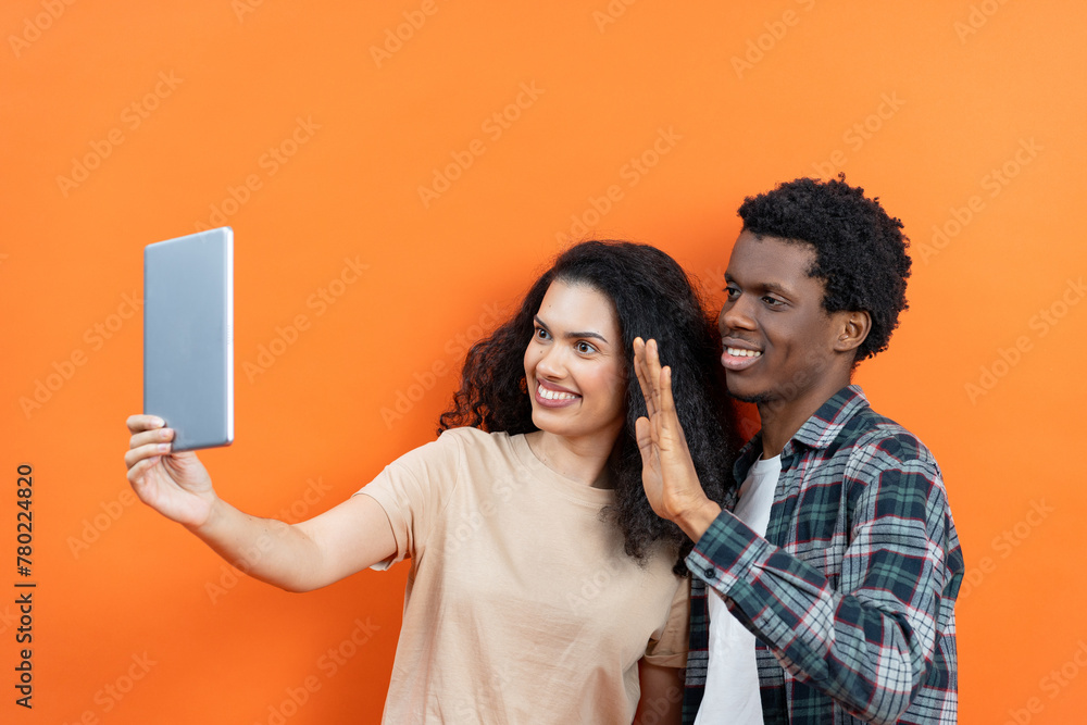 Happy Couple Video Calling On Tablet, Technology Connection and Communication Concept, Casual Home Lifestyle, Modern Gadgets, Cheerful Multiracial Relationship, Indoor Virtual Meeting - obrazy, fototapety, plakaty 