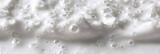 White foam texture background, closeup view of shampoo or cosmetic product