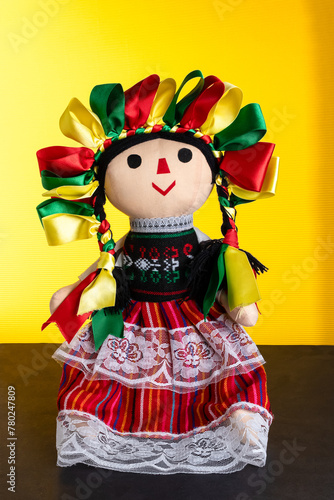 traditional mexican folkloric doll with a yellow background