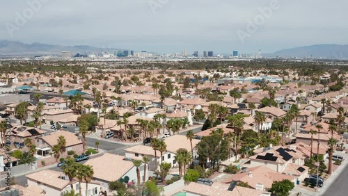 Aerial moving shot of Henderson Las Vegas suburb, palm trees and city skyline