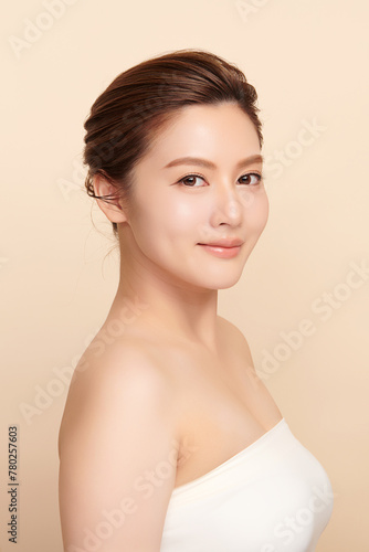 Beautiful young asian woman with clean fresh skin on beige background, Face care, Facial treatment, Cosmetology, beauty and spa, Asian women portrait. © kitthanes