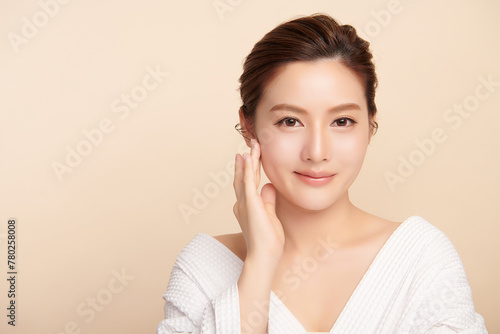 Beautiful young asian woman with clean fresh skin on beige background, Face care, Facial treatment, Cosmetology, beauty and spa, Asian women portrait. © kitthanes