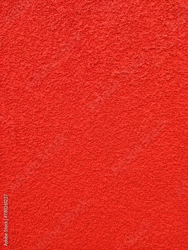 A bright red wall standing out against a plain white background, creating a stark contrast mobile vertical photo