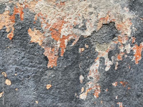 A peeling paint wall with layers of chipped and faded colors