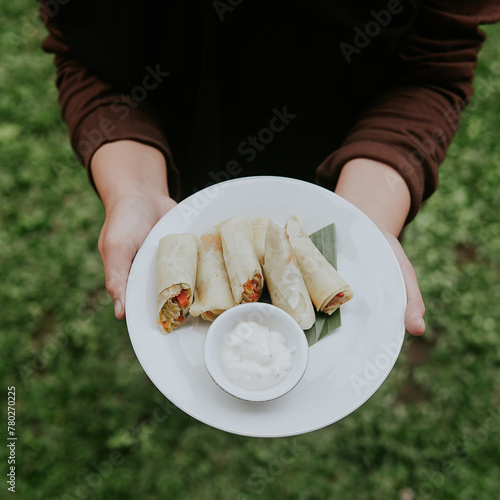 Lumpia Cakalang Person Holding Plate of Food in Hands