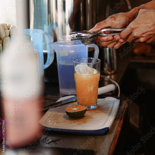Person Pouring Drink Into Glass, Refreshing Beverage Preparation in Action