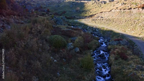 Mountain creek among autumn color meadows in highland area of Georgia photo