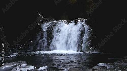 Waterfall in narrow ravine dropping into pool. Spring. Iceland. 2024 photo