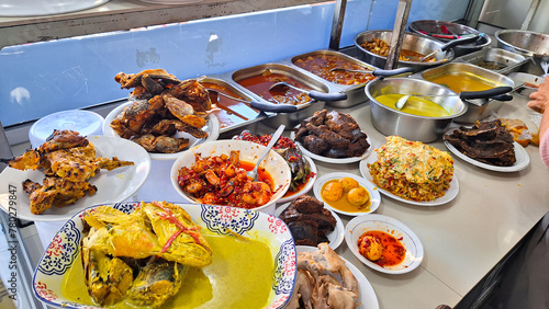 Warung Nasi Padang, Padang rice curry one of the most famous meals to be associated with Indonesia, a mix of rice and side dishes, like chicken pop, beef rendang, mix vegetables and egg balado. photo