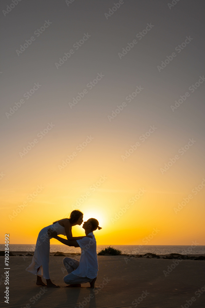 Vertical view of Romantic couple against sundown light in countryside Vertical view of Romantic couple against sundown light in countryside