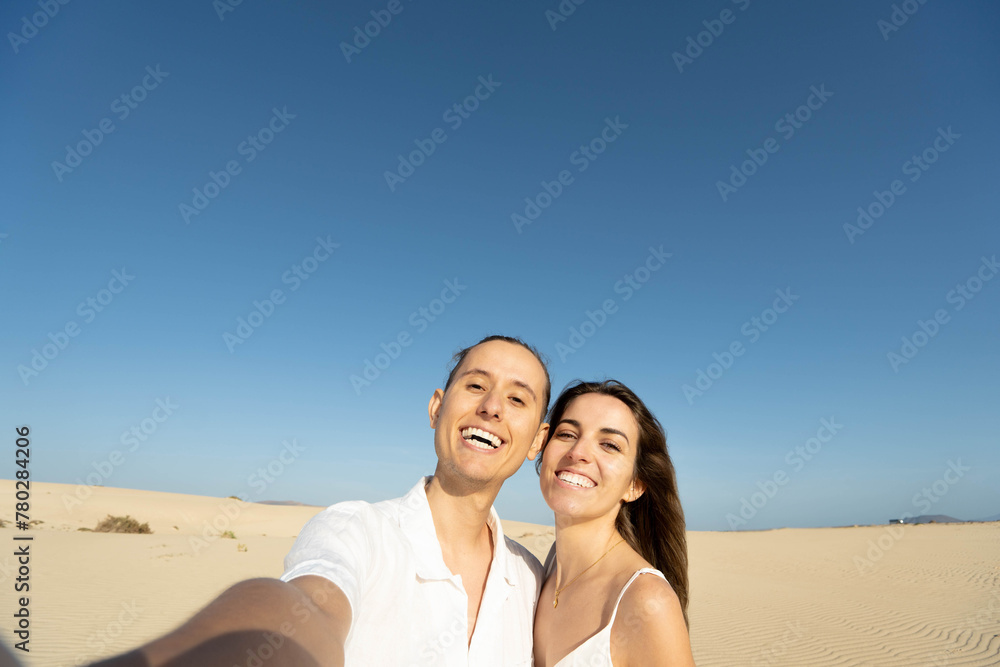 Happy couple with toothy smile taking selfie Happy couple with toothy smile taking selfie