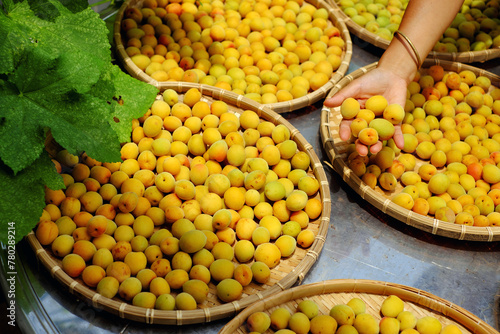 Group of basket fresh yellow ripe apricot, a tropical fruit at Vietnam North rich vitamin, nature medicine and good for health photo