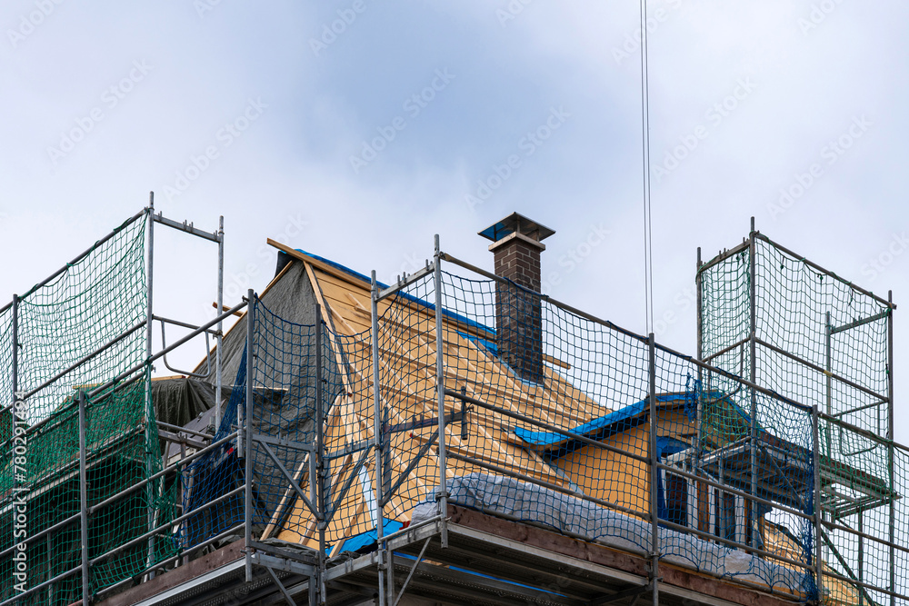 Roof of a private building covered with scaffolding for roof repair. Roof of a private building covered with scaffolding for roof repair.