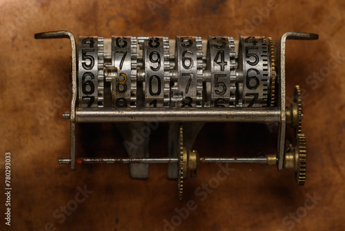 Abstract epoch counter. Old counter mechanism on a bronze sheet.