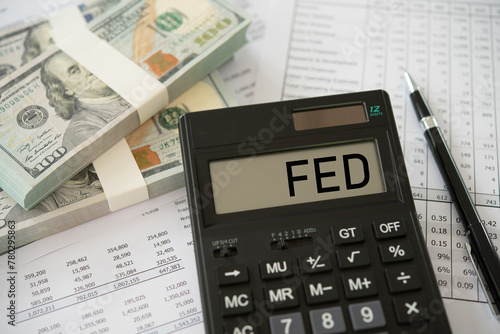 Federal Reserve bank interest rate policy. FED word on calculator with money and finance report. photo
