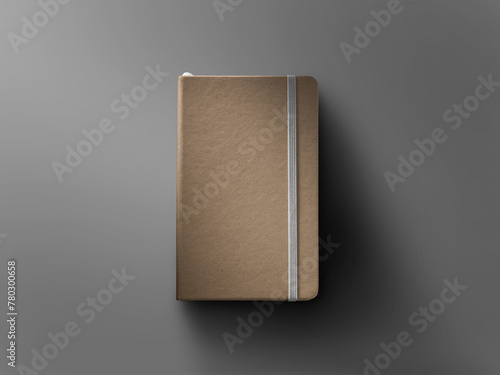Mockup of closed craft notebook, top view, with white elastic band, bookmark, textured hard cover, shadows on background.