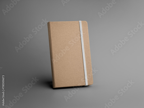 A template of a closed craft notebook with a white band, standing on a gray background.