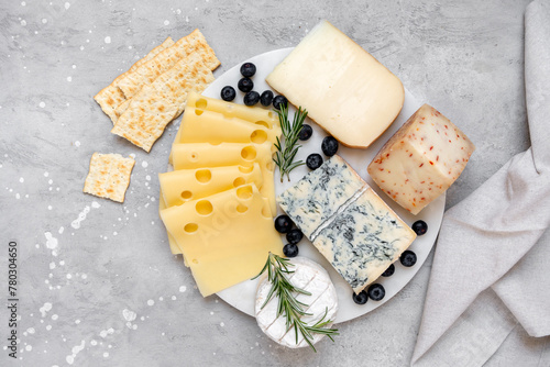 Italian and French gourmet Cheese platter with craft cheese assortment on a marble platter. hard cheeses, mold cheese, gorgonzola, pecorino, ementhal, Roquefort  photo