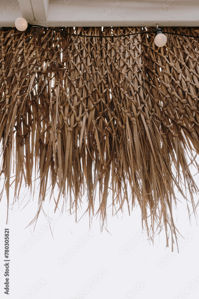 Fototapeta premium Thatching straw roof over bright sky view