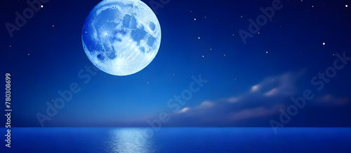 The full moon is shining brightly in the night sky  casting its reflection on the calm surface of the body of water below