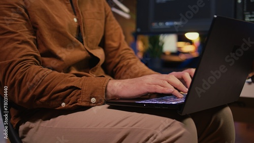 Remote programmer starting job shift in personal office at home, taking laptop out of bag. Teleworker unpacking backpack, writing lines of code on notebook keyboard, camera B close up