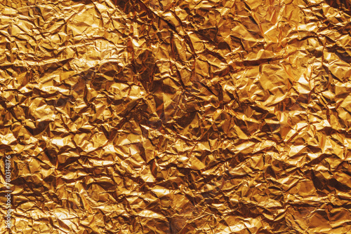 Background of golden wrapping paper crumpled and creased as texture
