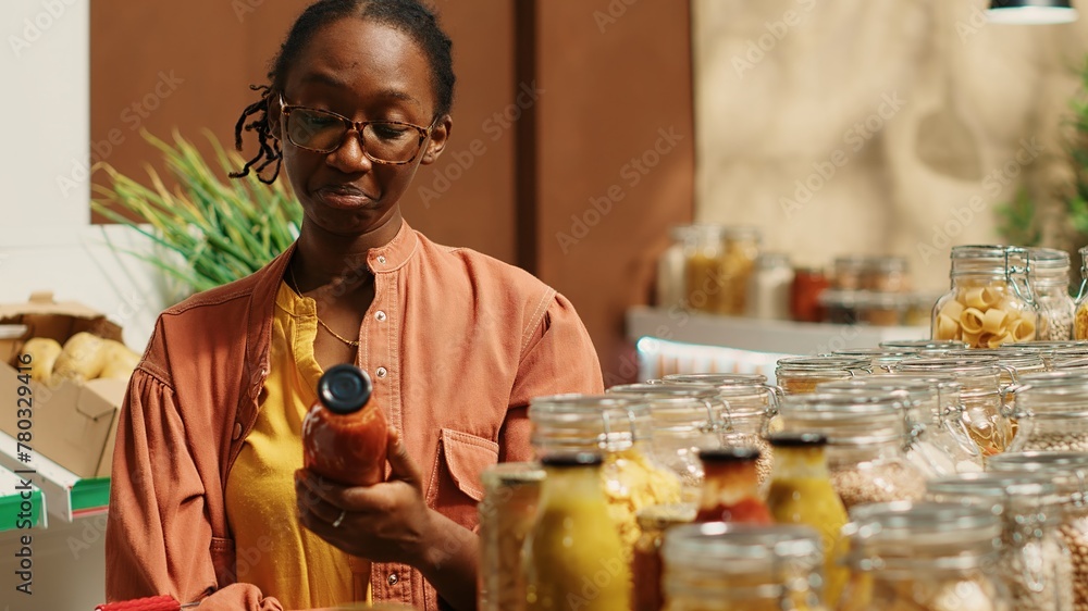 Regular client choosing vegan pasta and homemade sauce from supermarket display, shopping for pantry items at local farmers market to promote sustainable lifestyle. Bulk products. Camera 1. Regular client choosing vegan pasta and homemade sauce from supermarket display, shopping for pantry items at local farmers market to promote sustainable lifestyle. Bulk products. Camera 1.