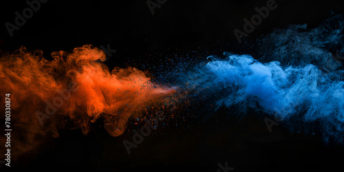 Creating a vibrant cloud of dust with rainbow colors on a black background is a concept for the Holi festival.Blue and orange colored powder explosions over black background. Holi paint powder splash