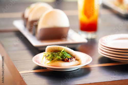 Pork belly bao bun on a small plate photo