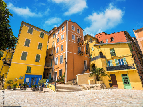 Colorful houses under blue sky in Menton, France.