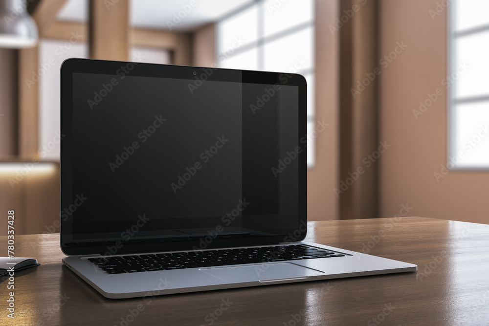 Close up of modern designer desktop with empty laptop and blurry office in the background. Mock up, 3D Rendering. Close up of modern designer desktop with empty laptop and blurry office in the background. Mock up, 3D Rendering.