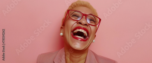 Professional black business woman laughing hysterically, pink background photo