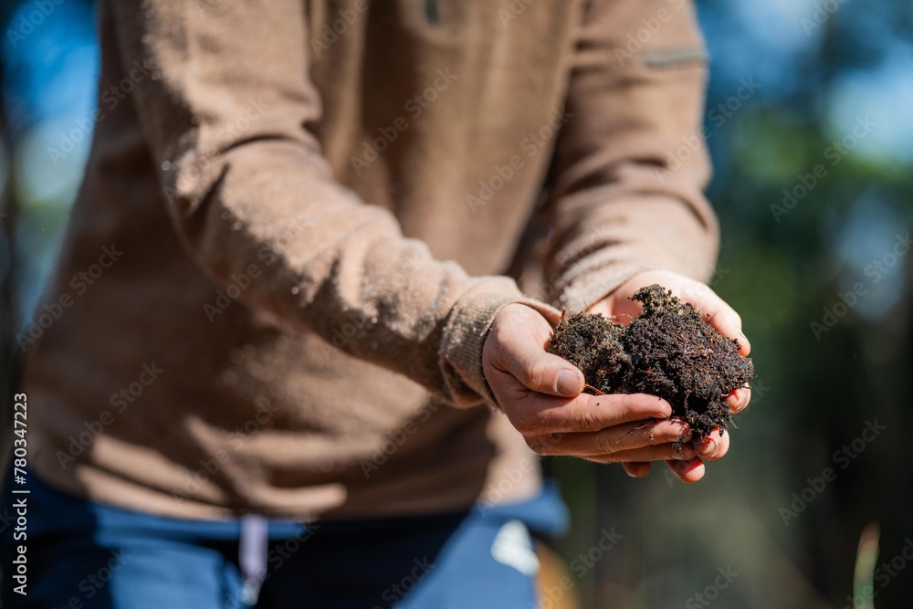 regenerative organic farmer, taking soil samples and looking at plant growth in a farm. practicing sustainable agriculture in australia regenerative organic farmer, taking soil samples and looking at plant growth in a farm. practicing sustainable agriculture in australia