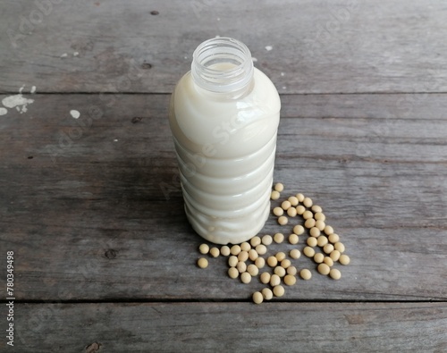 Soy milk with soybean on wood background