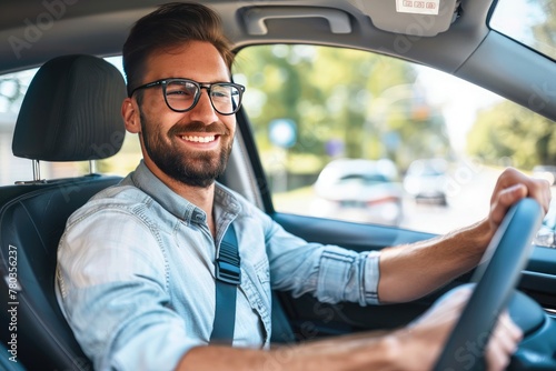 Handsome young man is driving a car and smiling driving a car with a clear view of the city through the window. showcasing safe driving with a seatbelt