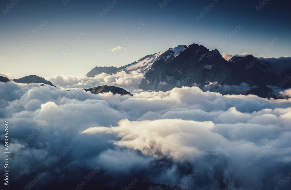 Morning fog shrouded the rocky peaks. Glacier Marmolada, Italian Alps, Dolomites, South Tyrol, Europe.