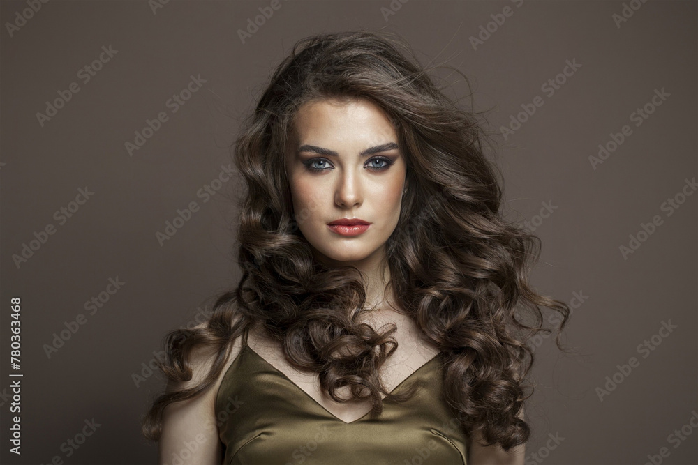 Lovely young brunette female model with long brown wavy hair and makeup closeup portrait Lovely young brunette female model with long brown wavy hair and makeup closeup portrait