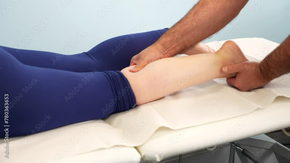 Physiotherapist massaging calf muscles of woman, relaxing legs massage. Closeup Physiotherapist massaging calf muscles of woman, relaxing legs massage. Closeup