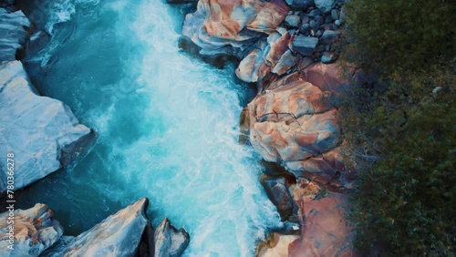 4K aerial view of Chandra river flowing between rocky structures in Lahaul, Himachal Pradesh, India. Nature landscape. Blue river water. photo